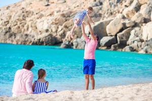 Young family having fun on the beach photo