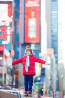 Adorable little girls have fun on Times Square in New York City photo