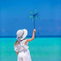 Adorable little girl at beach during summer vacation photo