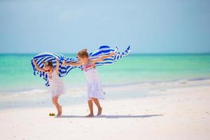 Adorable little girls at beach during summer vacation photo