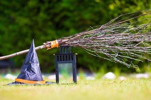 View of Halloween Pumpkins, witch's hat and rake outdoor photo