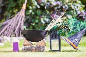 View of Halloween Pumpkins, witch's hat and rake outdoor photo