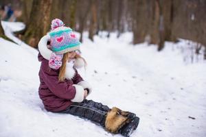 Adorable little girl during winter vacation outdoors photo