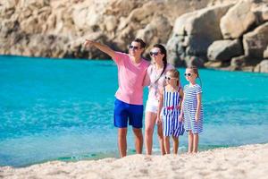 Family with kids on the beach in Greece photo