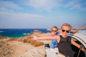 Kids on vacation travel by car. Summer holiday and car travel concept photo