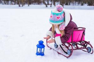 Adorable little girl having fun during winter vacation photo