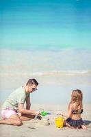 Father and little kid enjoying beach summer tropical vacation. photo
