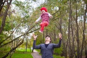 Young father with his cute little daughter have fun outdoor photo