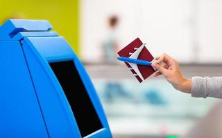 Terminal for self-check-in for flight or buying airplane tickets at airport photo