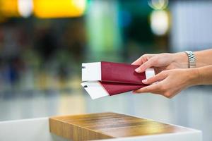 Closeup passports and boarding pass at the reception area in airport inside photo