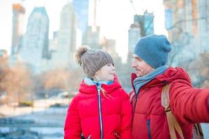 Family of dad and little kid taking selfie photo in Central Park at New York City