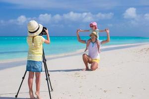 Little cute girl making photo of her family