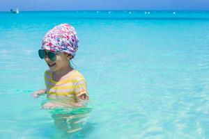 Happy little girl have fun at the sea during summer vacation photo