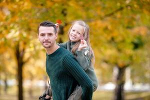 Family of dad and kid on beautiful autumn day in the park photo