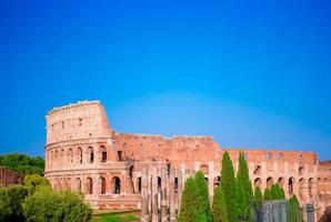 Colosseum or Coliseum background blue sky in Rome, Italy photo