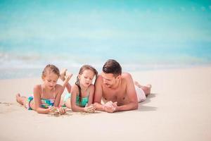Father and kids enjoying beach summer tropical vacation photo