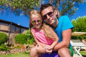 Portrait of father and little daughter at tropical vacation having fun outdoor photo