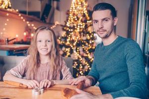 Family baking gingerbread cookies on Xmas vacation photo