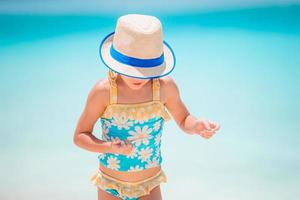 Adorable little girl at beach on her summer vacation photo