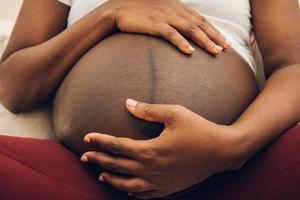 woman holding her belly  with his hands photo