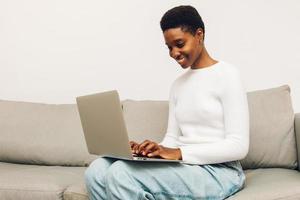 woman using laptop at home photo