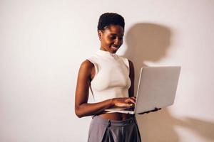 black woman person using laptop photo