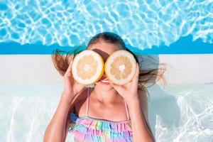 Little adorable girl in outdoor swimming pool photo