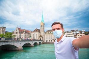 Young man background the old european city take selfie photo