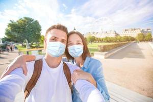 Happy young couple taking selfie in Paris on european vacation photo