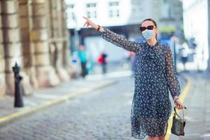 Portrait of a beautiful happy woman standing on the street holding shopping bags smiling photo