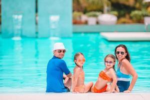 Happy family of four on beach vacation together photo