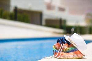 Colorful beach bag, straw hat and airplane model at summer photo