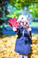 Cute little girl at warm sunny autumn day outdoor photo