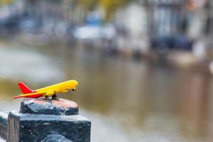 Little white airplane model background of canal in Amsterdam photo