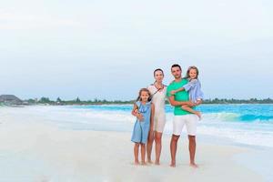 Family of parents and kids on beach vacation photo