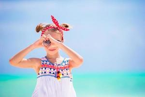 Little girl at beach during caribbean vacation. Portrait of beautiful kid background blue sky photo