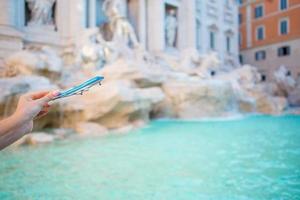 Small toy plane on background of Fountain of Trevi in Rome. photo