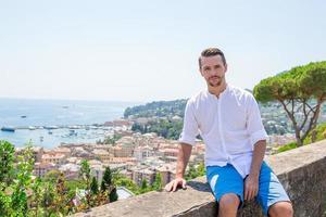 Happy young boy background the old coastal town Rapallo in Liguria photo