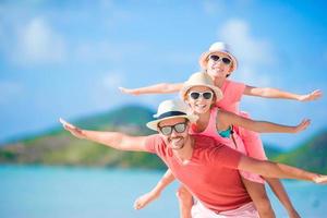 Father and kids enjoying beach summer tropical vacation photo