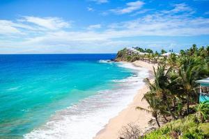 Idyllic tropical beach with white sand, turquoise ocean water and blue sky on Caribbean island photo