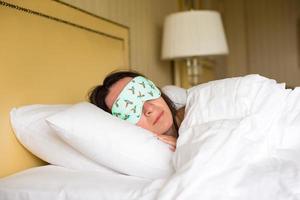 Young attractive woman sleeping in the bed photo