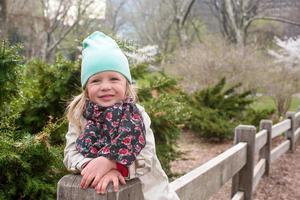 Pretty little girl at beauty autumn landscape background photo