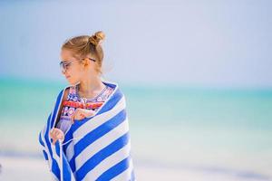 Adorable little girl at beach during summer vacation photo