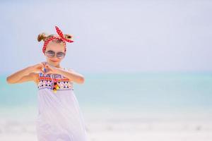 Cute little girl at beach during caribbean vacation photo