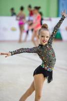 Little gymnast training on the carpet and ready for competitions photo