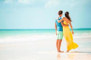 Young couple on white beach during summer vacation. photo