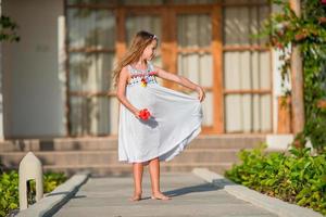 Adorable little girl during beach vacation having fun photo