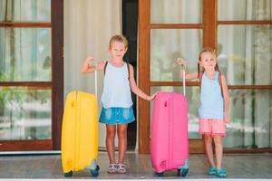 Kids with two luggages ready to travel photo