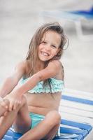 Portrait of beautiful girl on the beach dancing photo