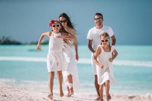 Young family of four on vacation have fun photo